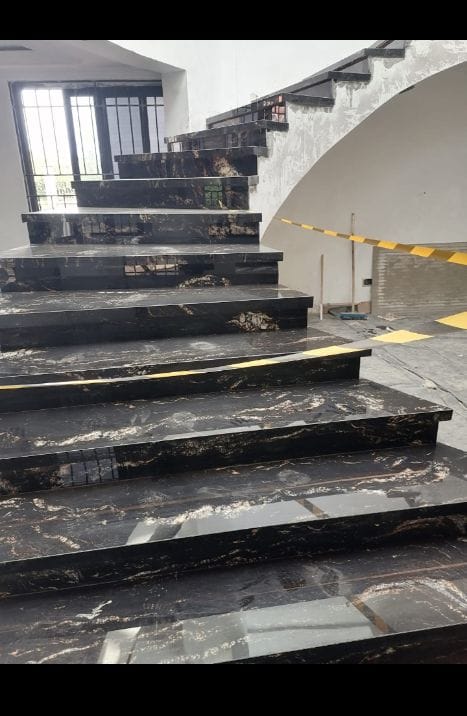 Luxury natural stone stairs expertly fabricated and installed by Imperial Granite, featuring polished stone treads with a modern and elegant finish.